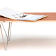 Illustration for article titled Giant Paperclips Turn Any Slab of Wood Into a Sturdy Table